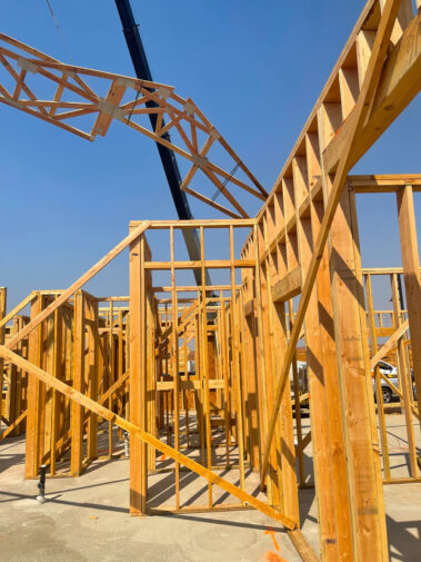Roof truss being lowered by truck